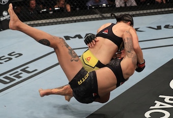 Livia Renata Souza (top) takes down Sarah Frota.