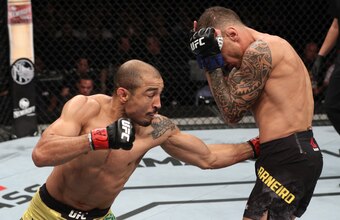 Jose Aldo (left) lands the body shot on Renato Moicano.