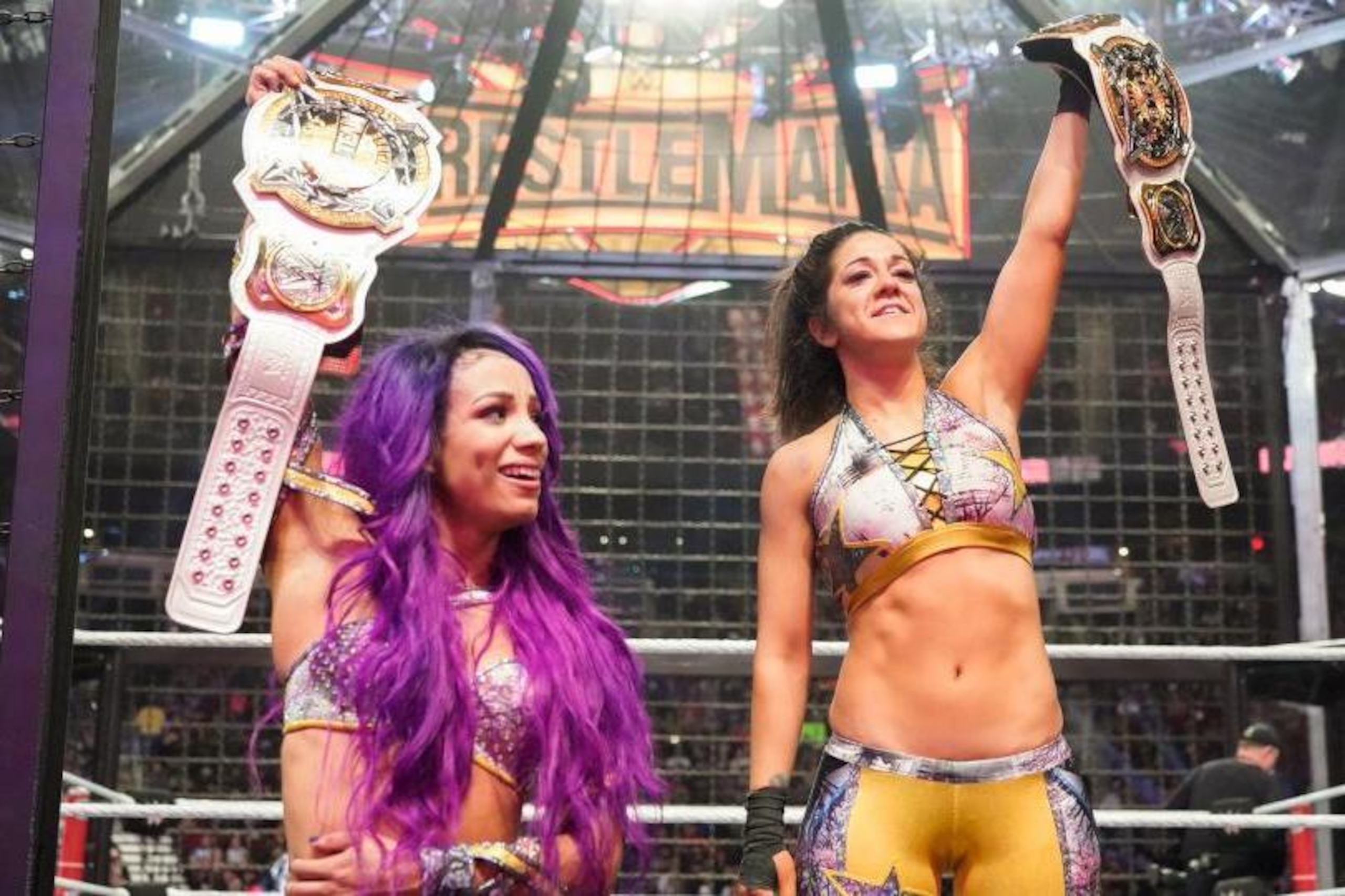 Sasha Banks and Bayley with their women's tag team titles. Sasha Banks and Bayley with their women's tag team titles.