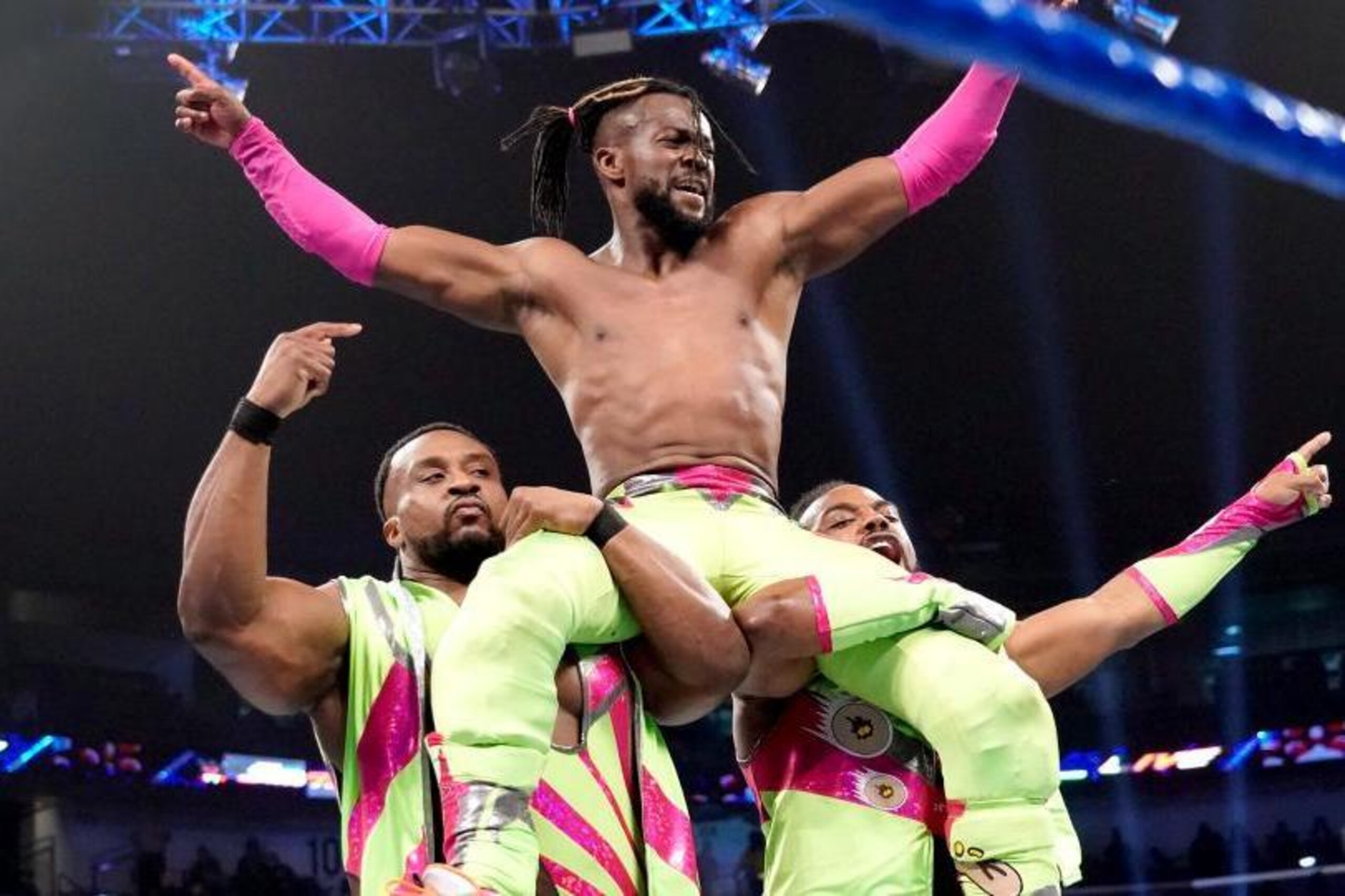 Big E and Xavier Woods celebrating with Kofi Kingston.