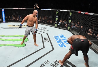 Junior Dos Santos (left) after hurting Derrick Lewis with a body strike