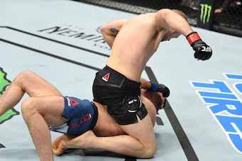 Alex Morono (top) finished Zak Ottow with strikes on the undercard.