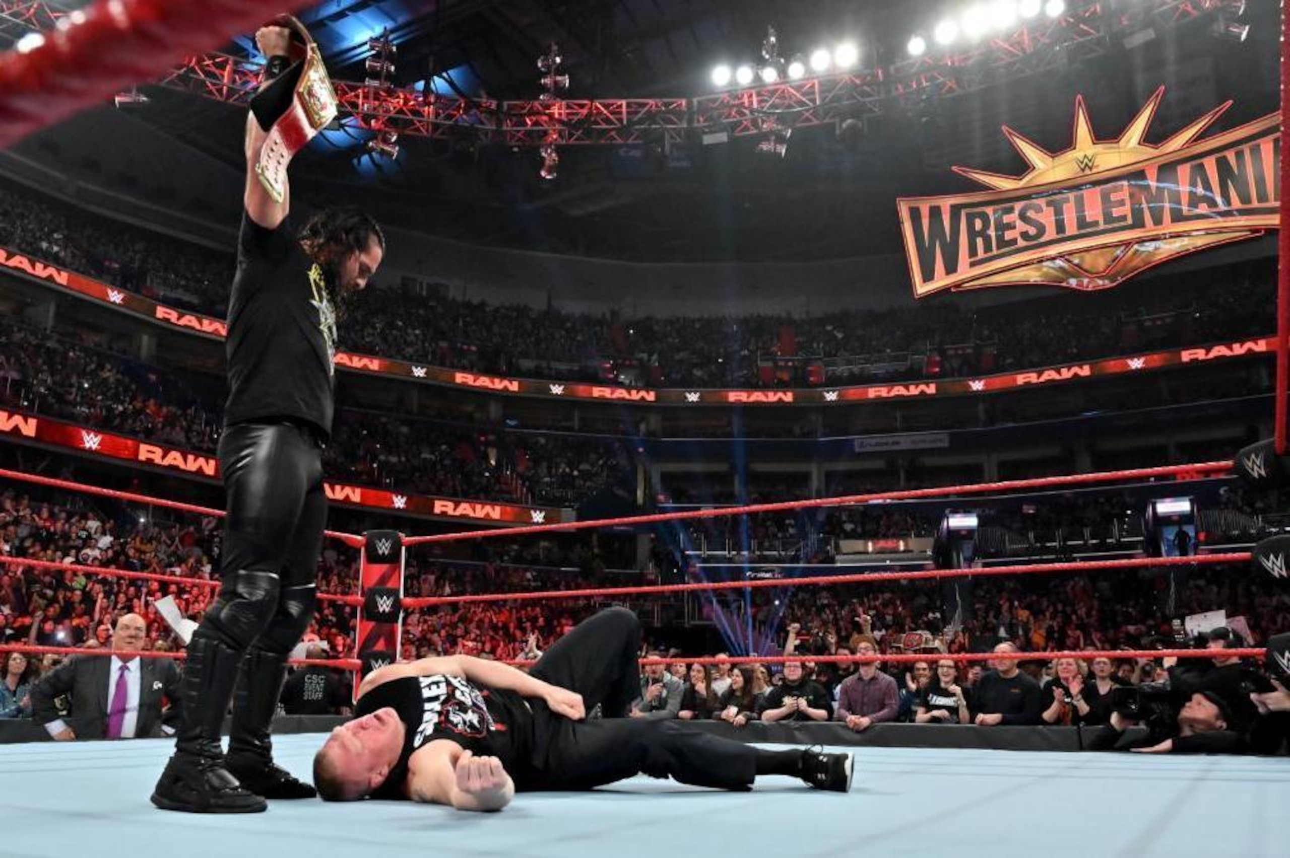 Seth Rollins standing tall over Brock Lesnar. Seth Rollins standing tall over Brock Lesnar.
