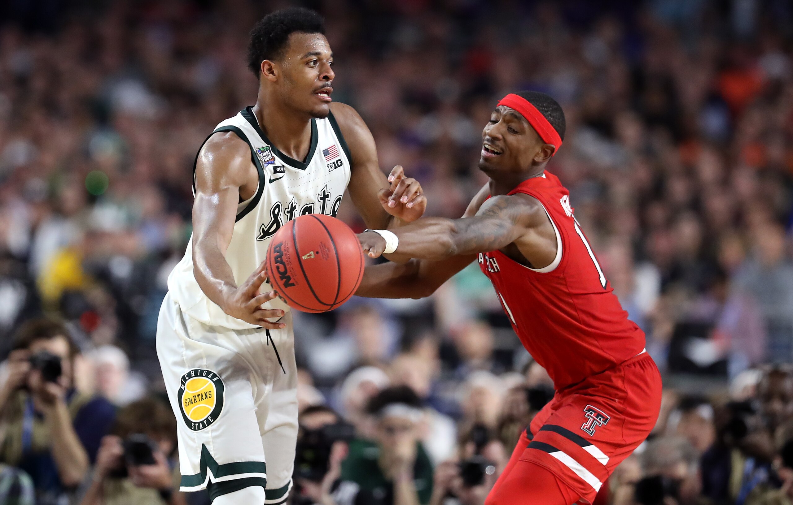 Tariq Owens swats the ball away from Xavier Tillman.