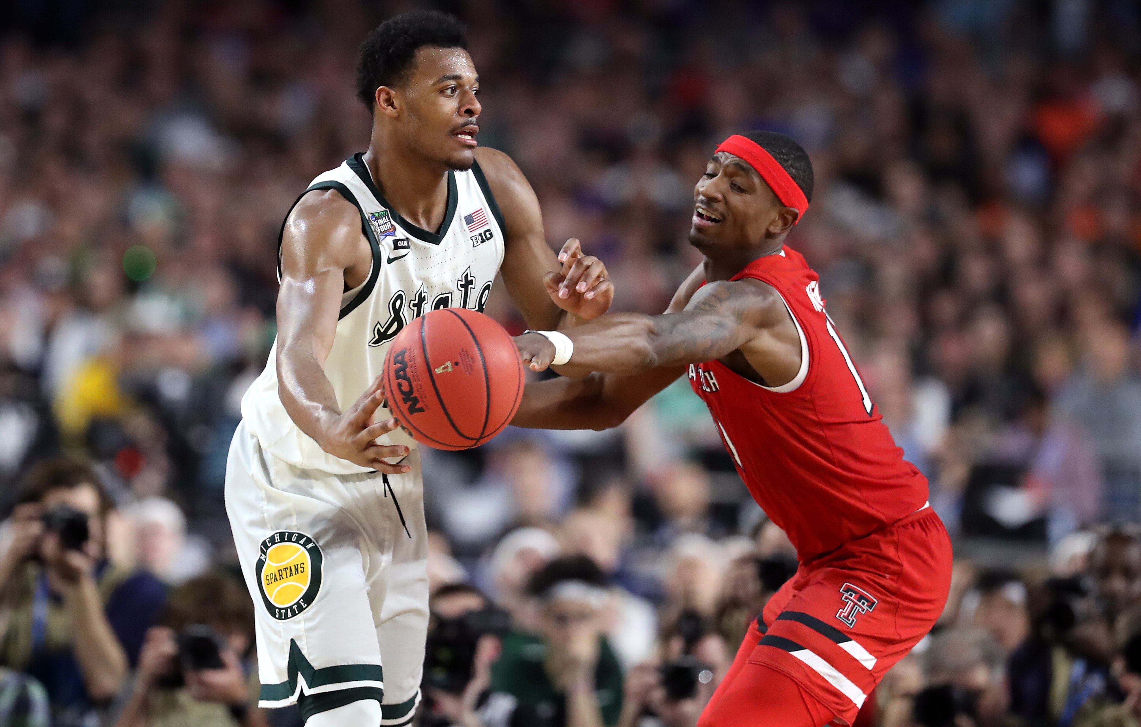 Tariq Owens swats the ball away from Xavier Tillman. Tariq Owens swats the ball away from Xavier Tillman.