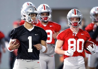 Justin Fields (1) and C.J. Saunders (80)