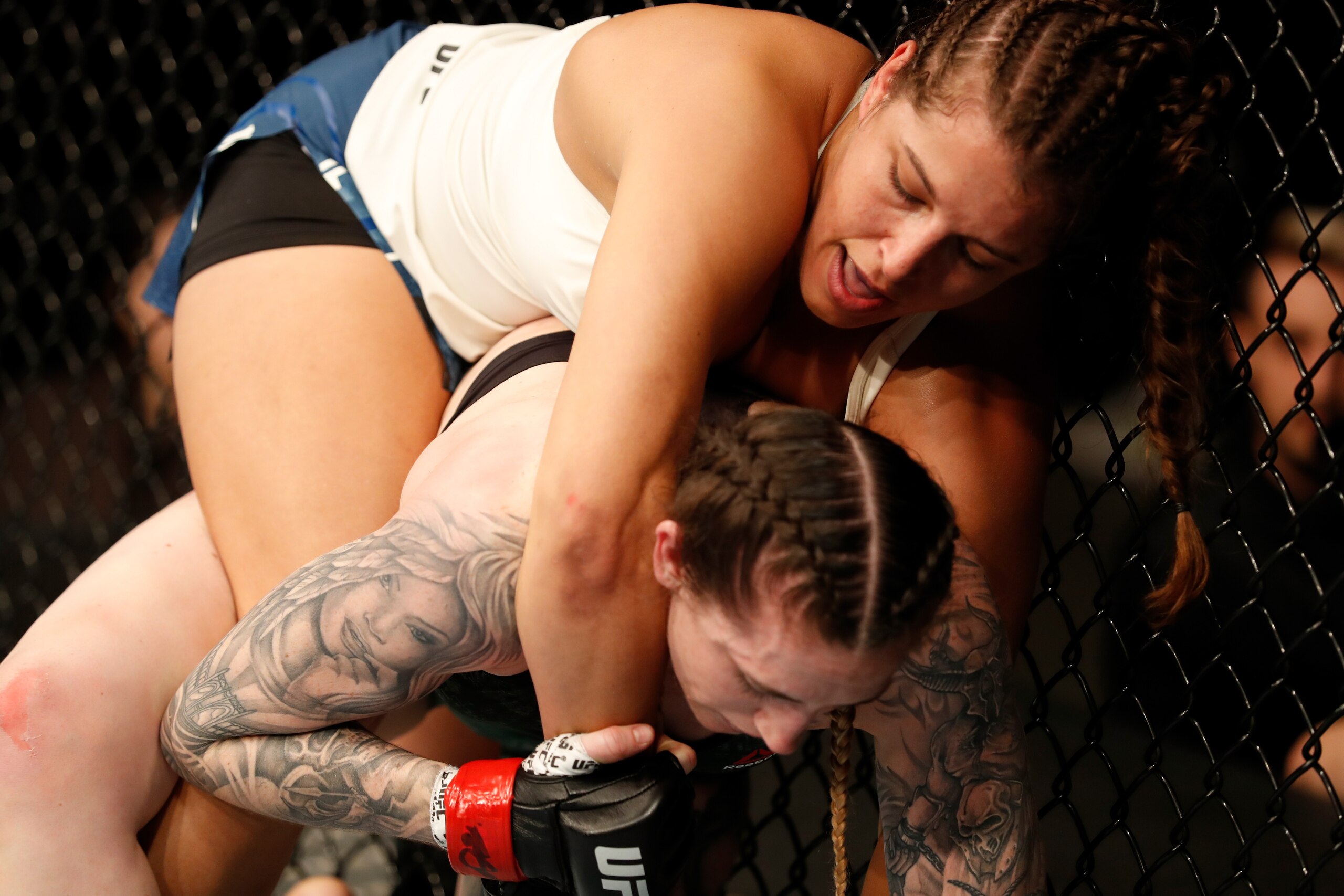 Felicia Spencer (top) grapples Megan Anderson.
