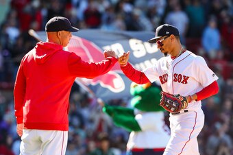 Alex Cora (L) and Mookie Betts (R)