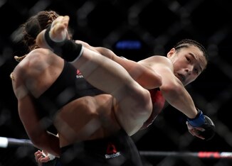 Weili Zhang (right) kicks Tecia Torres