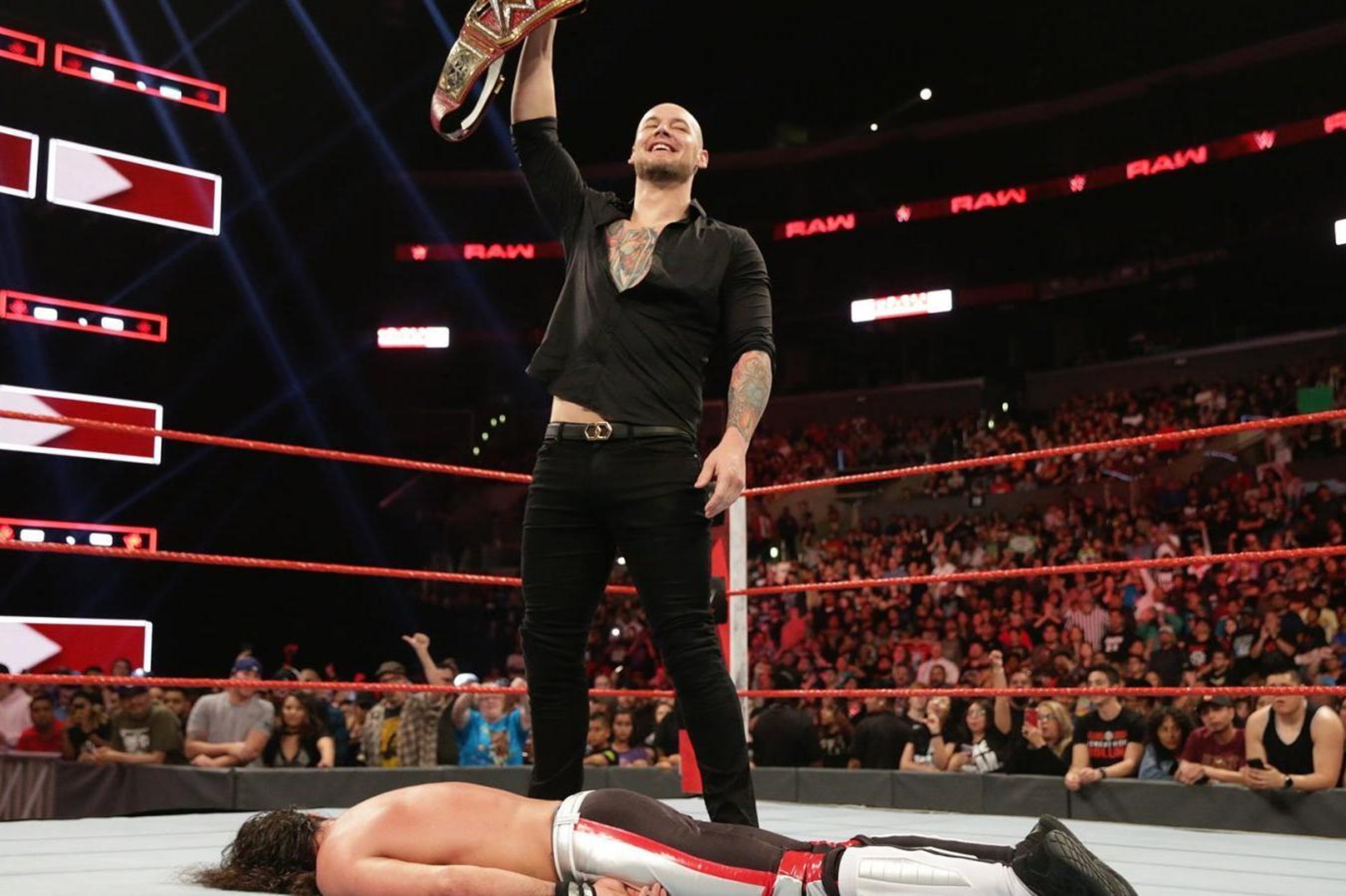 Baron Corbin standing over Seth Rollins. Baron Corbin standing over Seth Rollins.