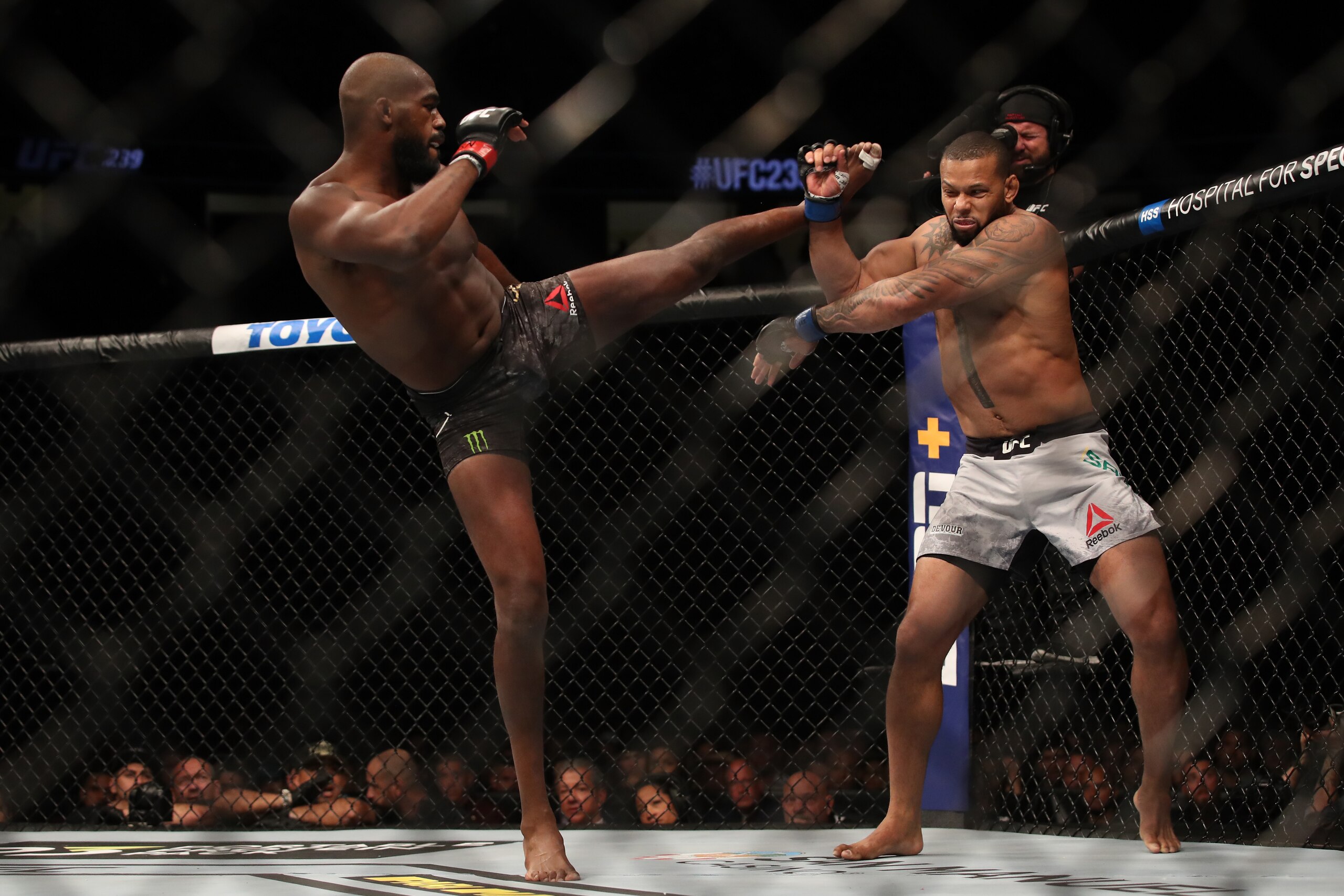 Jon Jones (left) kicks Thiago Santos