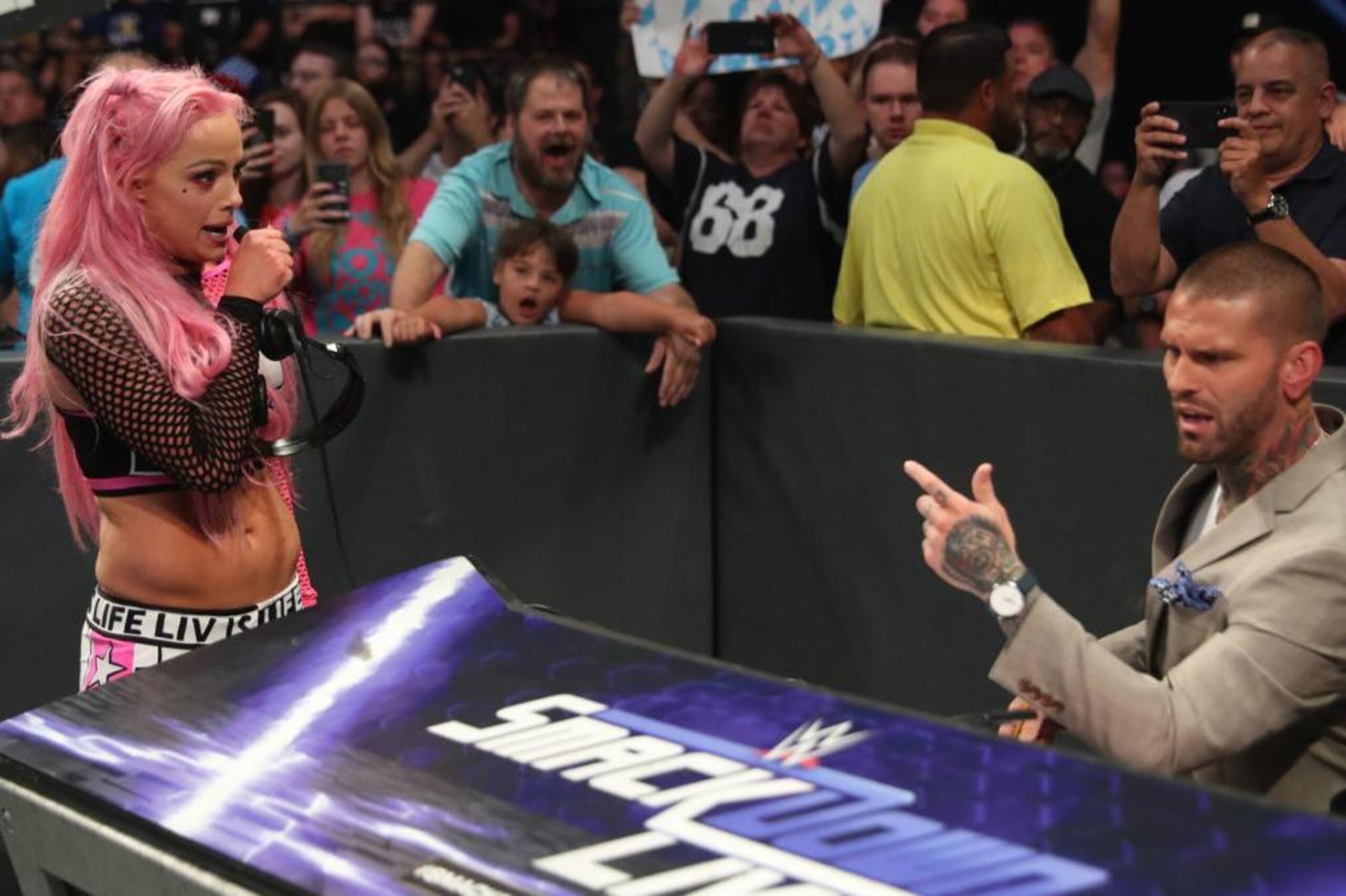 Liv Morgan steals Corey Graves' headset.