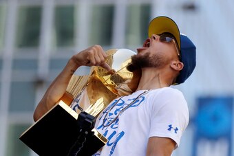 Golden State Warriors' Stephen Curry shouts as he carries the Larry O'Brien trophy during the team's NBA championship parade, Tuesday, June 12, 2018, in Oakland, Calif. (AP Photo/Marcio Jose Sanchez)