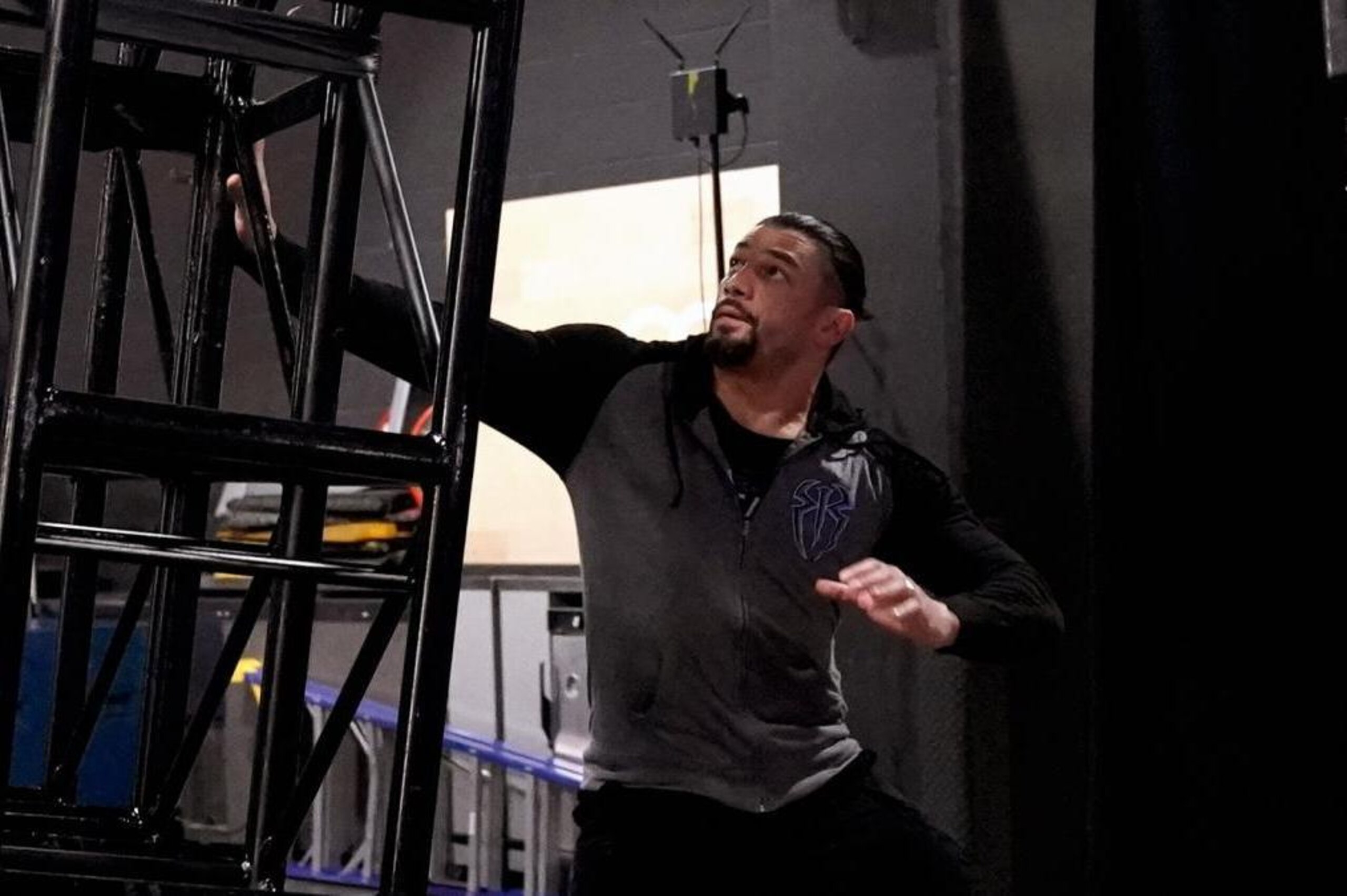 Roman Reigns as equipment is knocked on to him.