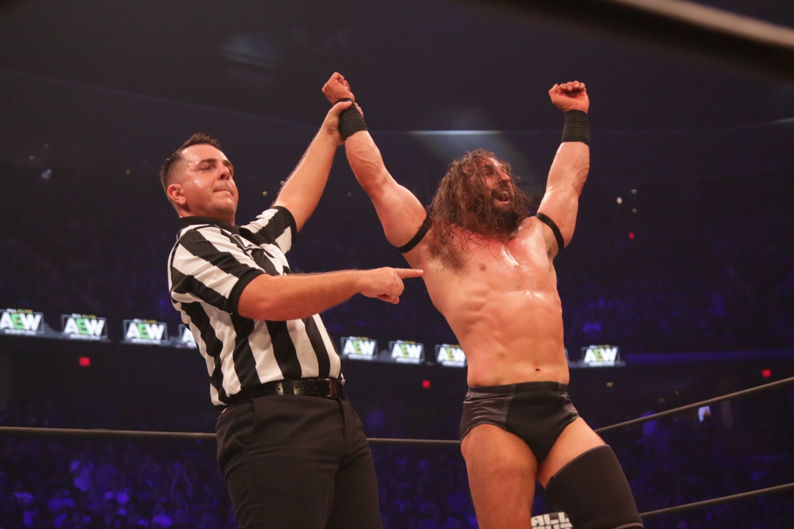 Pac celebrating his victory over Kenny Omega at All Out.