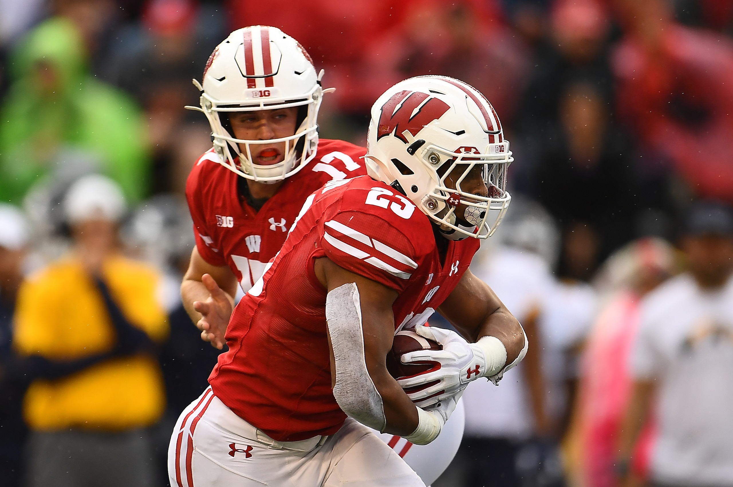 Wisconsin RB Jonathan Taylor (23) and QB Jack Coan (17)