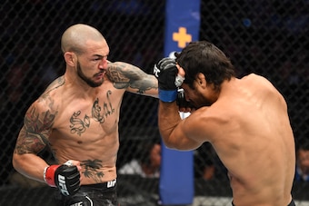 Cub Swanson (left) punches Kron Gracie.