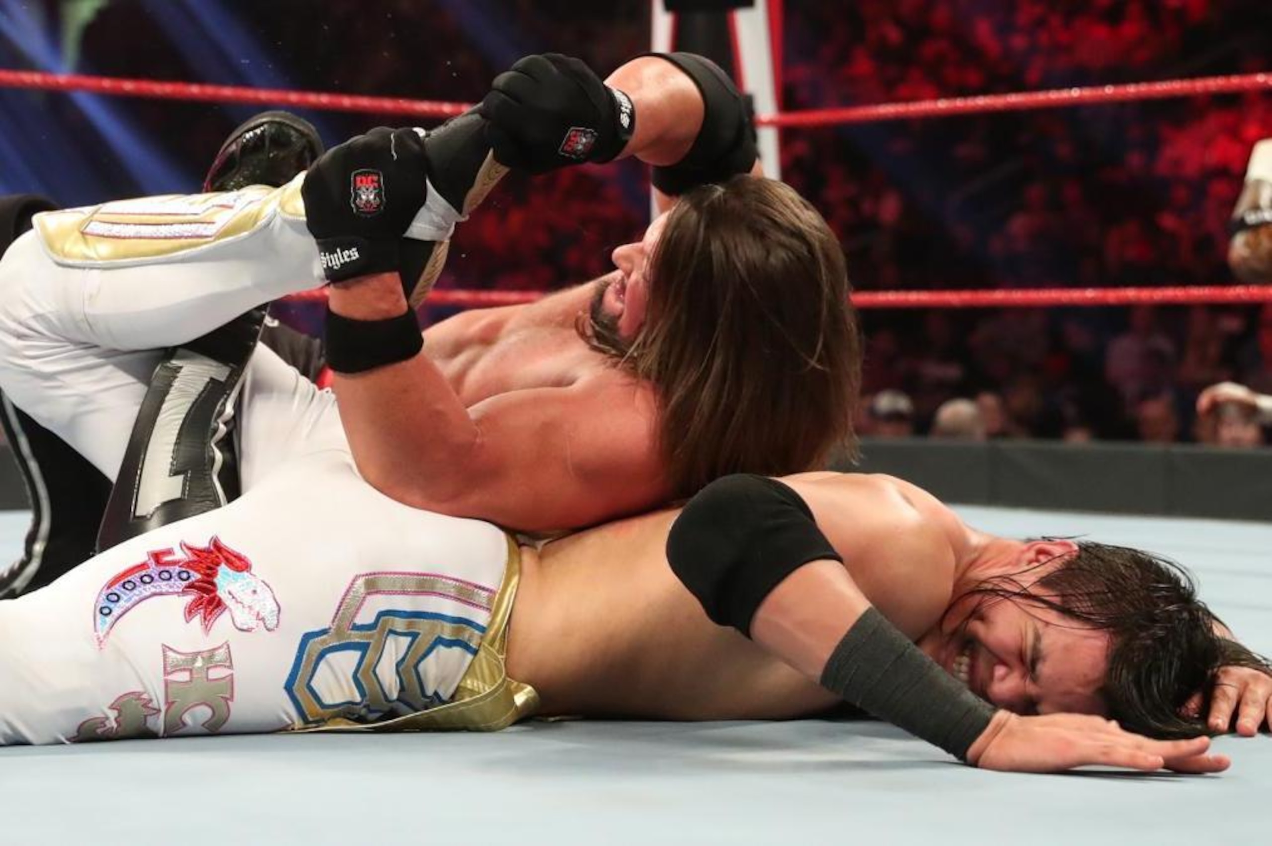AJ Styles with Humberto Carrillo in the Calf Crusher.