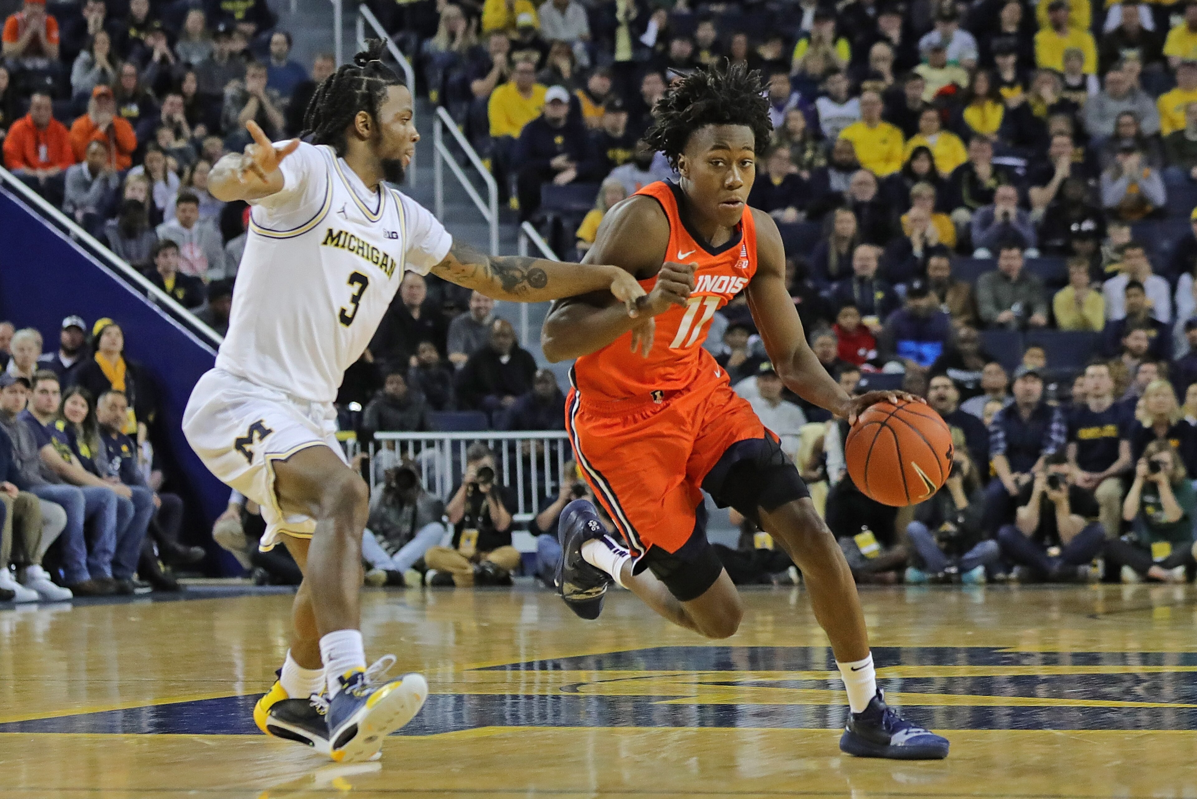 Michigan's Zavier Simpson and Illinois' Ayo Dosunmu