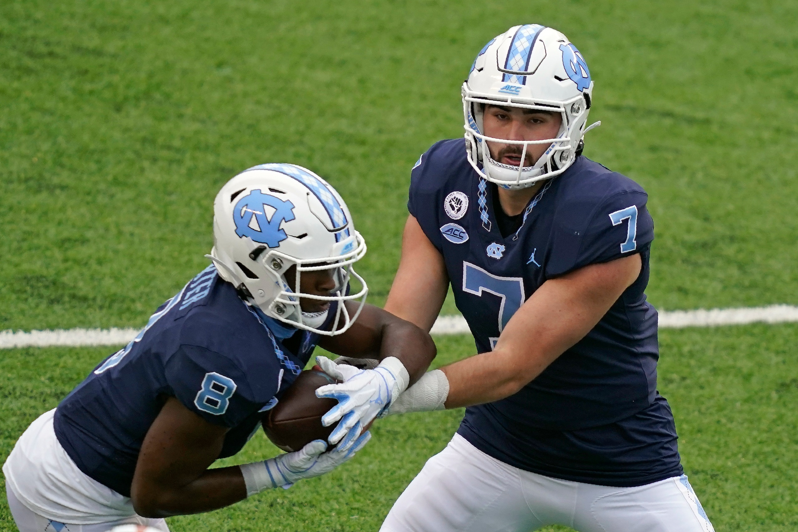 North Carolina's Michael Carter (8) and Sam Howell (7)