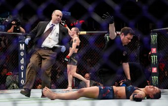 Valentina Shevchenko (background) celebrates after one of her knockouts