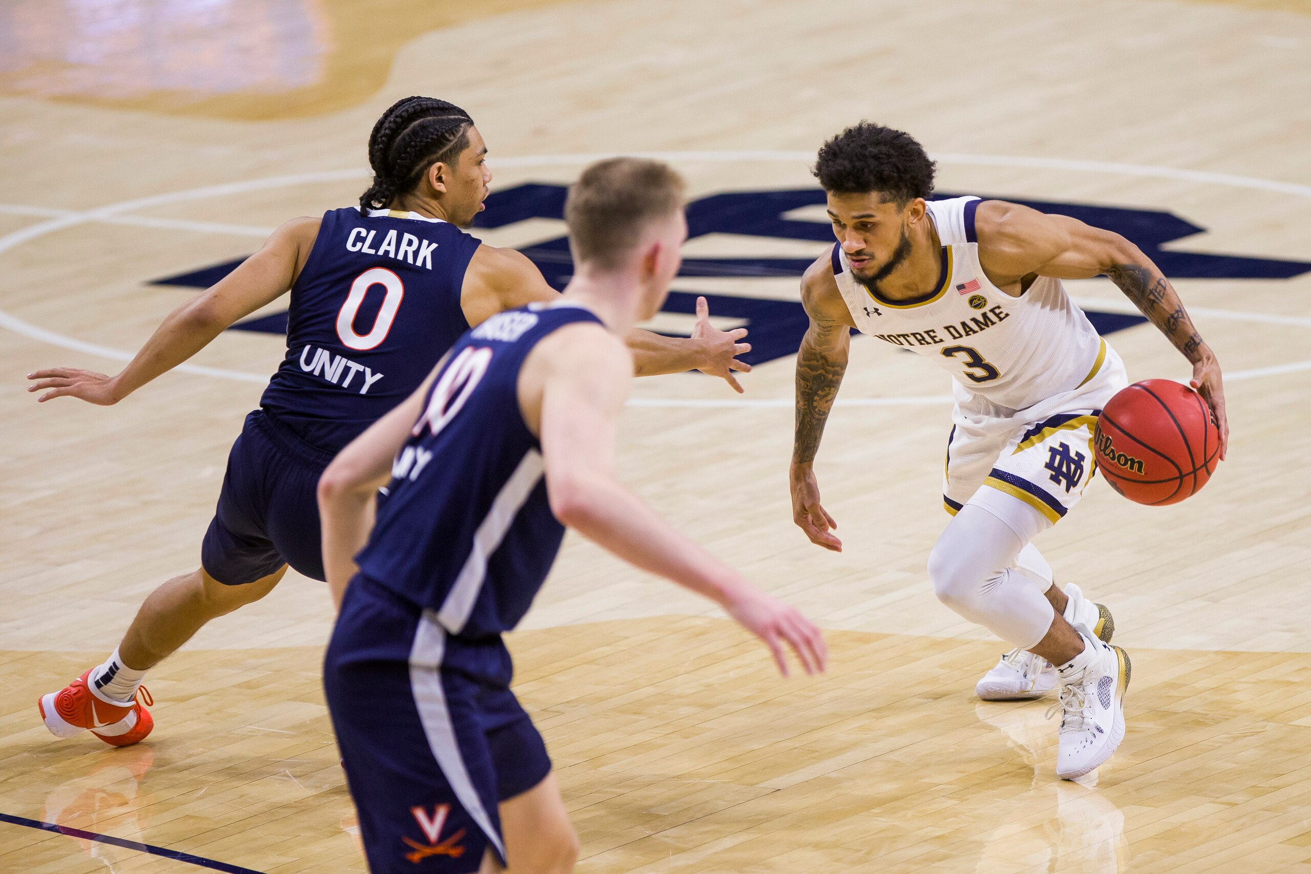 Virginia guard Kihei Clark and forward Sam Hauser guard Notre Dame guard Prentiss Hubb