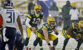 Green Bay Packers' Corey Linsley snaps the ball to Aaron Rodgers during the first half of an NFL football game against the Tennessee Titans Sunday, Dec. 27, 2020, in Green Bay, Wis. (AP Photo/Mike Roemer)