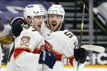 Florida Panthers center Frank Vatrano (77) celebrates with MacKenzie Weegar (52) after Vatrano scored a goal against the Nashville Predators in the third period of an NHL hockey game Tuesday, April 27, 2021, in Nashville, Tenn. (AP Photo/Mark Humphrey)