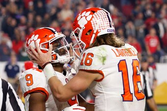 Jacksonville Jaguars running back Travis Etienne (left) and quarterback Trevor Lawrence (right)