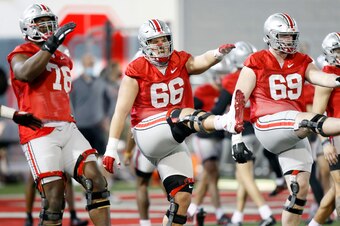 Ohio State's Nicholas Petit-Frere (78), Enokk Vimahi (66) and Trey Leroux (69)