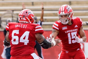 Louisiana's Shane Vallot (64) and Elijah Mitchell (15)