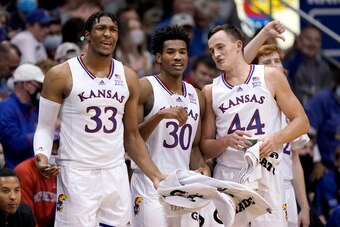 Kansas' David McCormack (33), Ochai Agbaji (30) and Mitch Lightfoot (44)