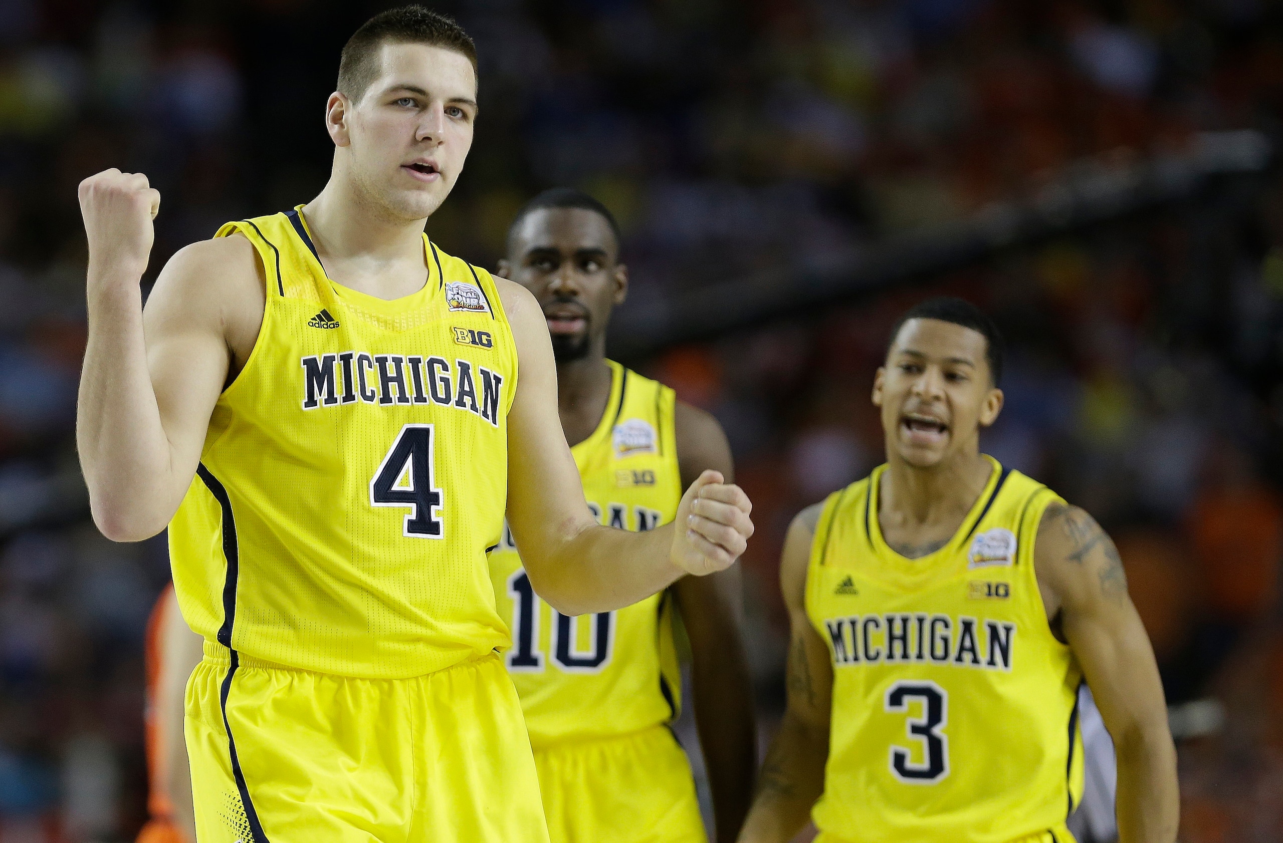 Michigan's Mitch McGary (4), Tim Hardaway Jr. (10) and Trey Burke (3)