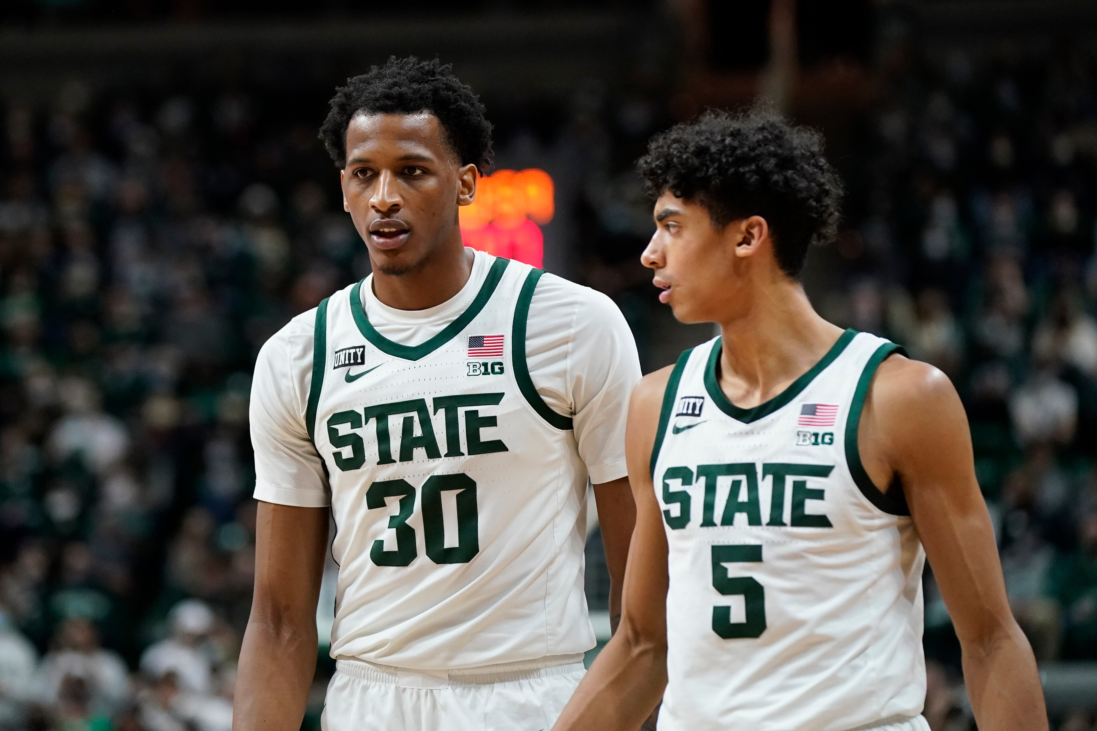 Michigan State's Max Christie (5) and Marcus Binhgam (30)