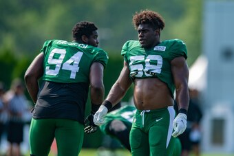 Jets defensive lineman Folorunso Fatukasi (left) and edge-rusher Carl Lawson (right)