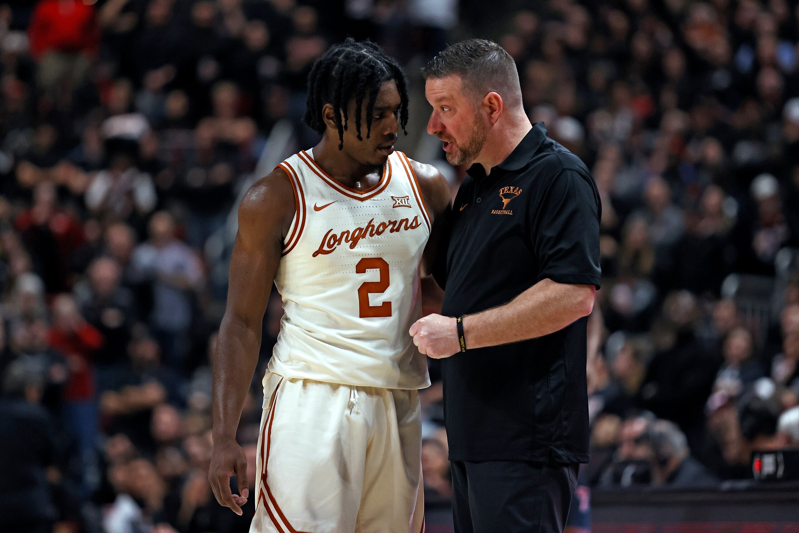 Texas' Marcus Carr (2) and Chris Beard