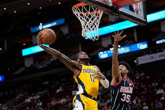 Indiana Pacers' Oshae Brissett goes up for a shot as Houston Rockets' Christian Wood (35) defends during the first half of an NBA basketball game Friday, March 18, 2022, in Houston. (AP Photo/David J. Phillip)