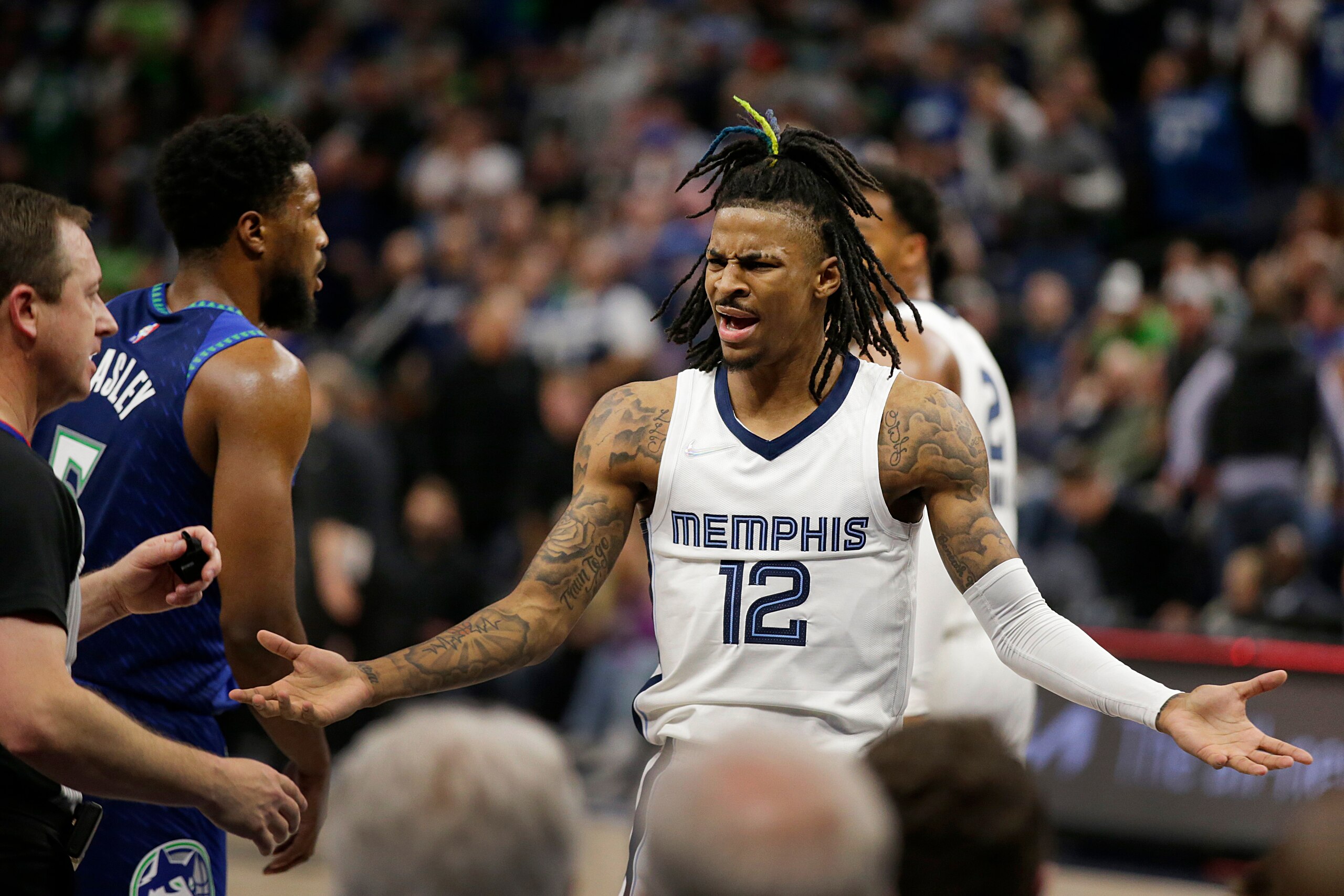 Memphis Grizzlies guard Ja Morant argues a call with referee Scott Twardoski during the first half of Game 3 of the team's NBA basketball first-round playoff series against the Minnesota Timberwolves on Thursday, April 21, 2022, in Minneapolis. (AP Photo/